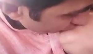 Pakistani couple topic and kissing surrounding car