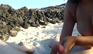 Young Spanish girl gives a blowjob at a public beach