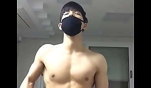 korean boy flexing his abs