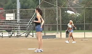 Concise shows 2 female athletes how nigh properly handle a big bat